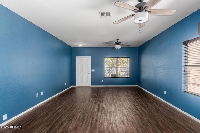 unfurnished room featuring baseboards, ceiling fan, and wood finished floors