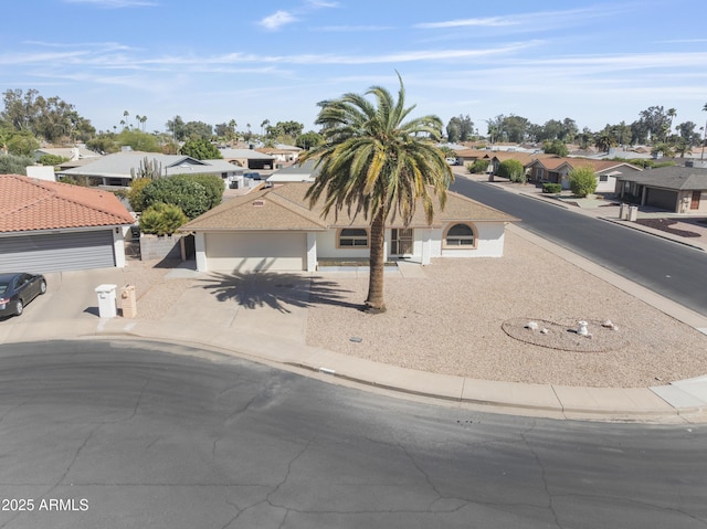 view of front of property with a garage, driveway, and a residential view