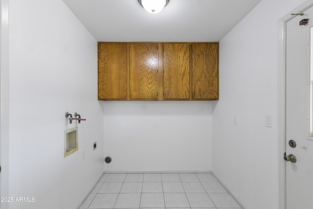 laundry room with cabinet space, light tile patterned floors, washer hookup, and hookup for an electric dryer