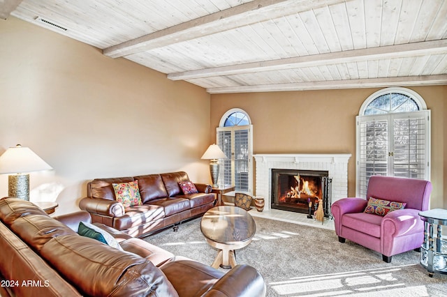 living room with beamed ceiling, carpet flooring, a fireplace, and wooden ceiling