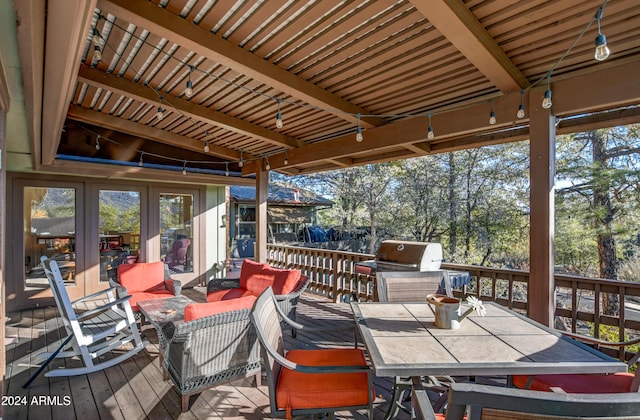 wooden deck with outdoor lounge area and area for grilling