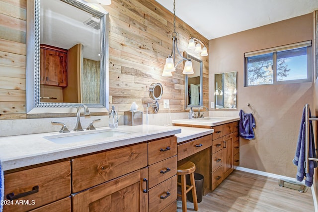 bathroom featuring hardwood / wood-style flooring, vanity, and wooden walls