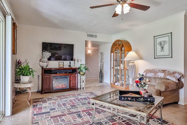 living area with crown molding, a fireplace, light tile patterned floors, visible vents, and baseboards