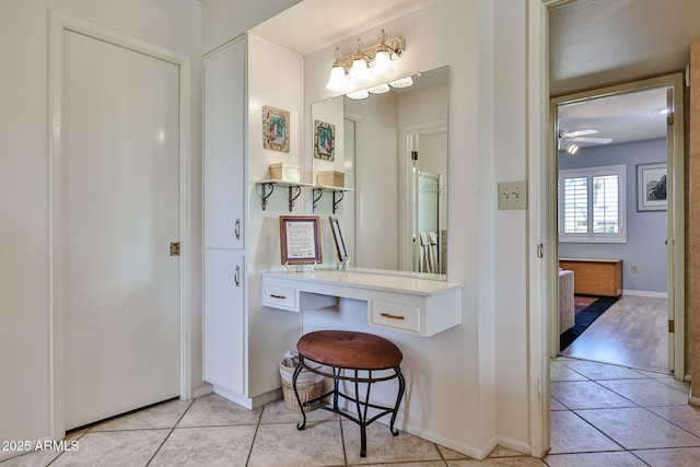 bathroom with ceiling fan, baseboards, and tile patterned floors