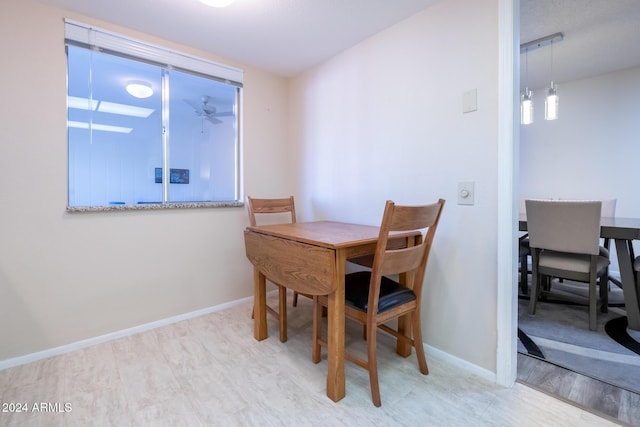 dining space featuring light hardwood / wood-style flooring and an inviting chandelier