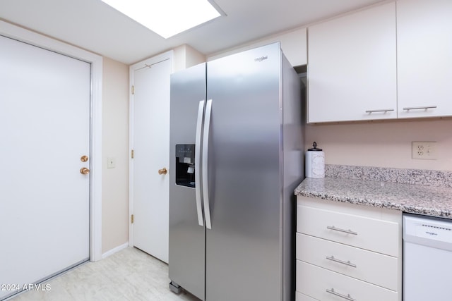 kitchen featuring dishwasher, white cabinetry, light stone countertops, and stainless steel fridge with ice dispenser