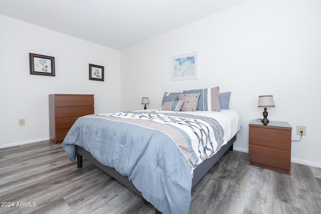 bedroom with dark wood-type flooring