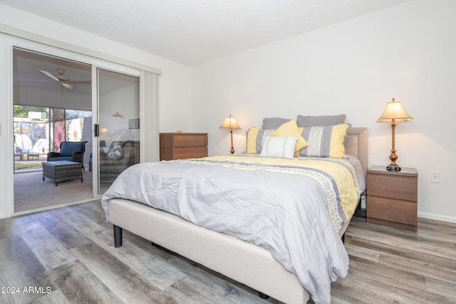 bedroom with hardwood / wood-style floors and access to exterior