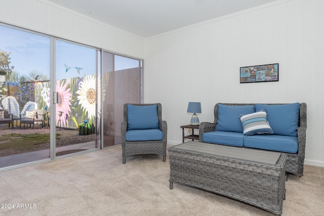 sitting room with light carpet and ornamental molding