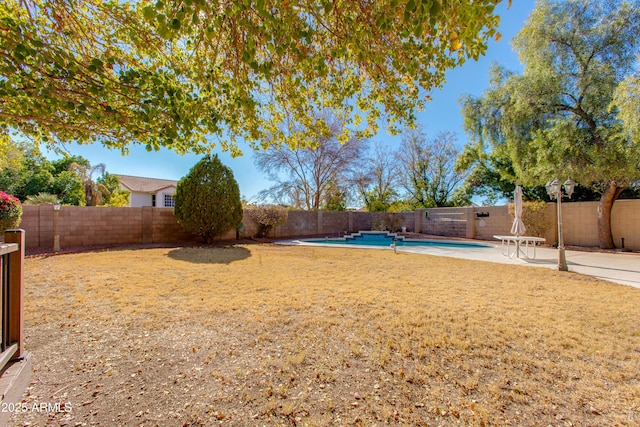 view of yard with a patio area and a fenced in pool