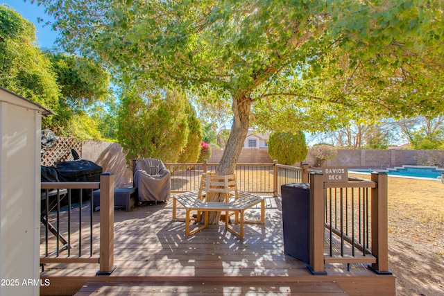 wooden terrace with a fenced in pool and a grill