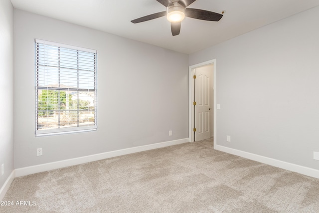 empty room with light colored carpet and ceiling fan