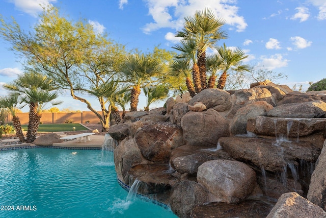 view of swimming pool featuring pool water feature