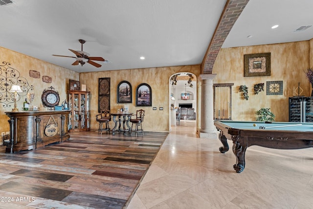 game room with wood walls, ornate columns, ceiling fan, and billiards