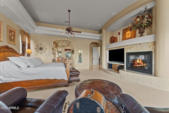 bedroom with ceiling fan and a tray ceiling