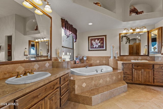 bathroom featuring a relaxing tiled bath, tasteful backsplash, tile floors, and dual bowl vanity