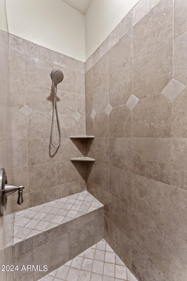 bathroom with a tile shower