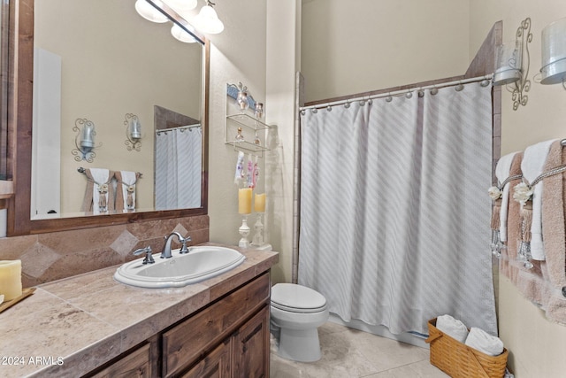 bathroom with tile floors, backsplash, toilet, and large vanity