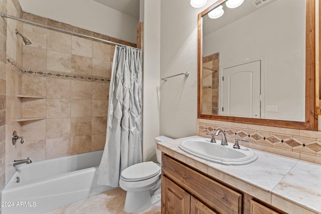 full bathroom featuring vanity with extensive cabinet space, shower / bath combination with curtain, tile flooring, and toilet