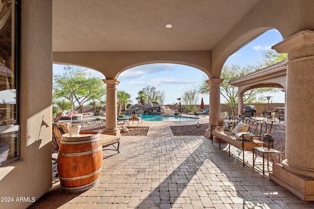 view of patio with a fenced in pool and a grill