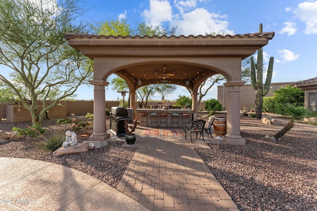 view of patio with a gazebo, a bar, and area for grilling