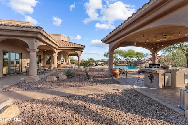 view of yard with a community pool, area for grilling, ceiling fan, and a patio area