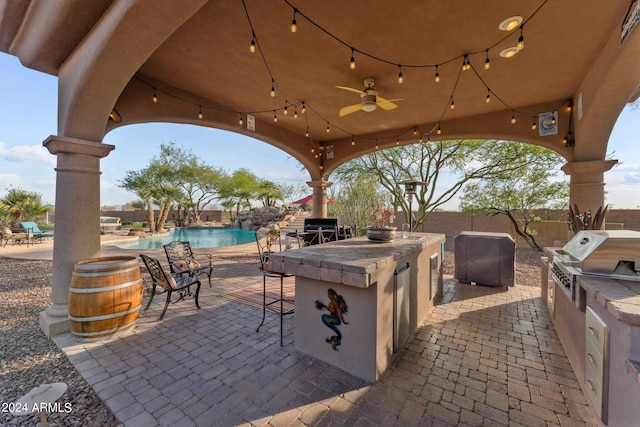 view of terrace featuring area for grilling, exterior bar, and a fenced in pool