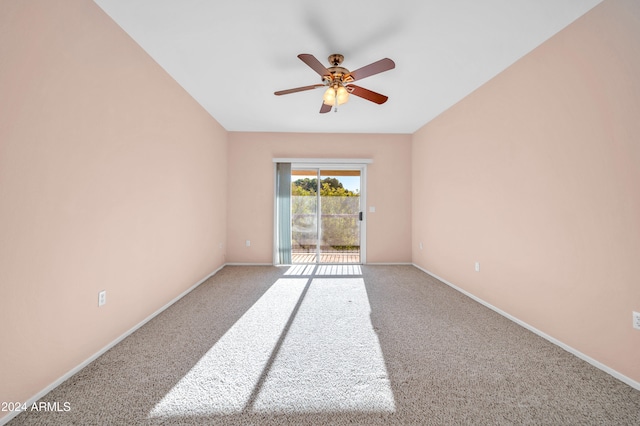 carpeted spare room with ceiling fan