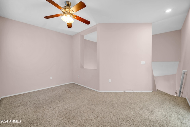 carpeted empty room with lofted ceiling and ceiling fan