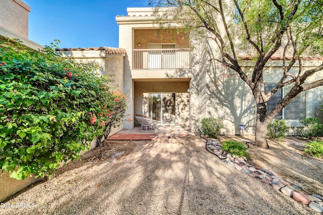 rear view of property with a balcony