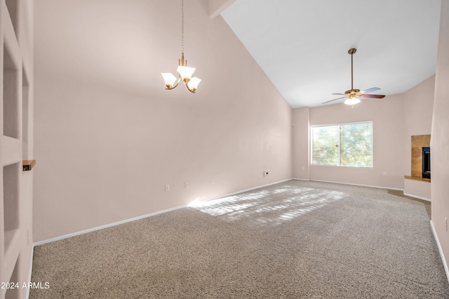 unfurnished living room featuring carpet flooring, beam ceiling, high vaulted ceiling, a tiled fireplace, and ceiling fan with notable chandelier