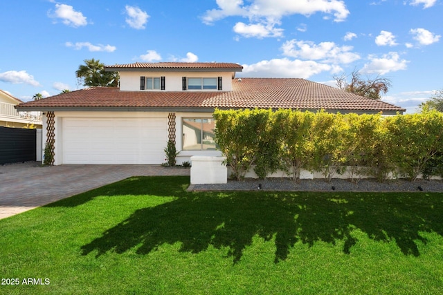 mediterranean / spanish house with a garage and a front lawn