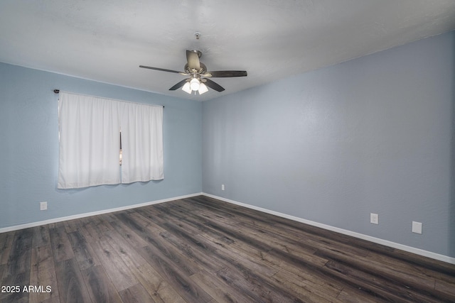 spare room with dark hardwood / wood-style floors and ceiling fan