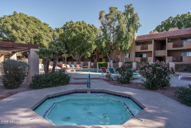 view of swimming pool featuring a hot tub