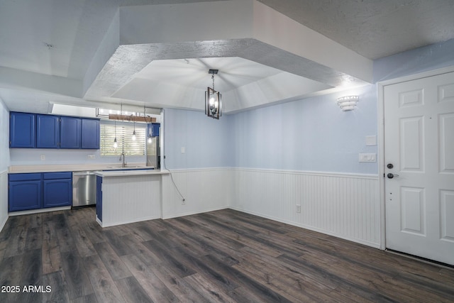 kitchen with pendant lighting, dishwasher, blue cabinets, and dark wood-type flooring