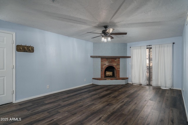 unfurnished living room featuring a textured ceiling, ceiling fan, a fireplace, and dark hardwood / wood-style floors