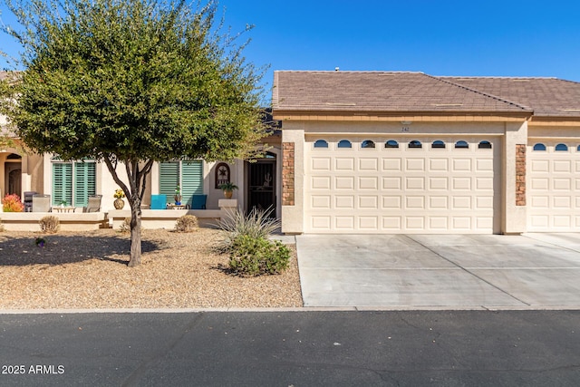 view of front of property featuring a garage, driveway, and stucco siding