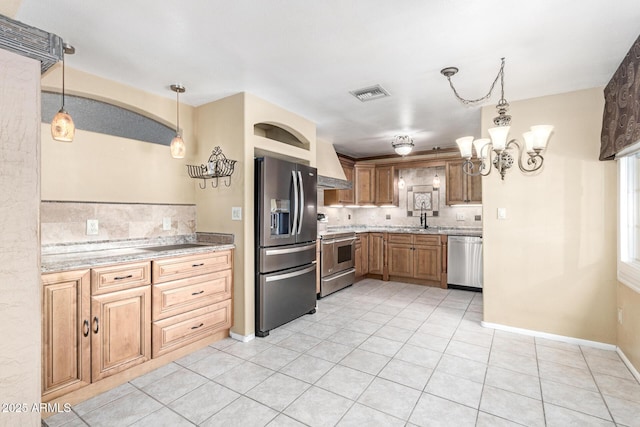 kitchen with premium range hood, tasteful backsplash, hanging light fixtures, light tile patterned floors, and stainless steel appliances