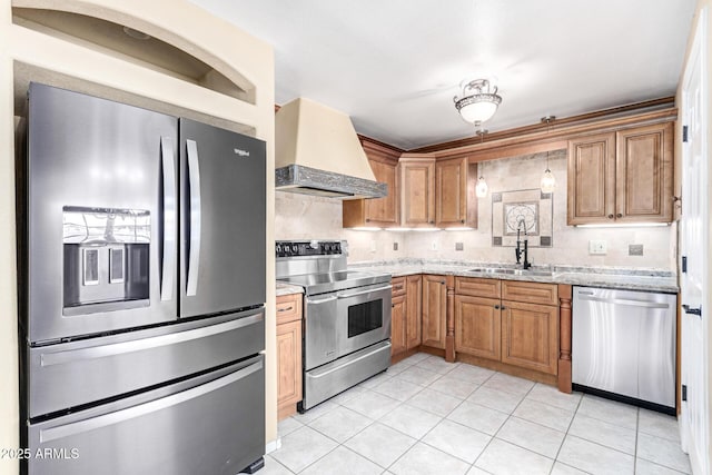 kitchen featuring appliances with stainless steel finishes, sink, light tile patterned floors, light stone countertops, and custom range hood