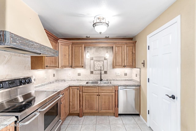 kitchen with sink, appliances with stainless steel finishes, premium range hood, tasteful backsplash, and light tile patterned flooring