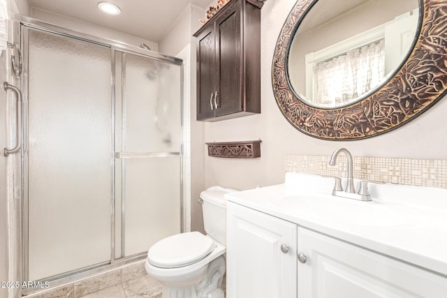 bathroom with vanity, toilet, and a shower with shower door