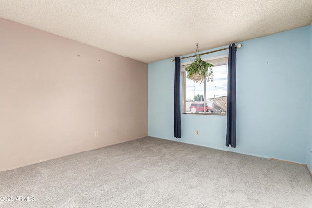 empty room with carpet and a textured ceiling