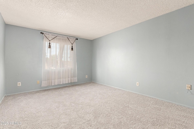 carpeted empty room with a textured ceiling