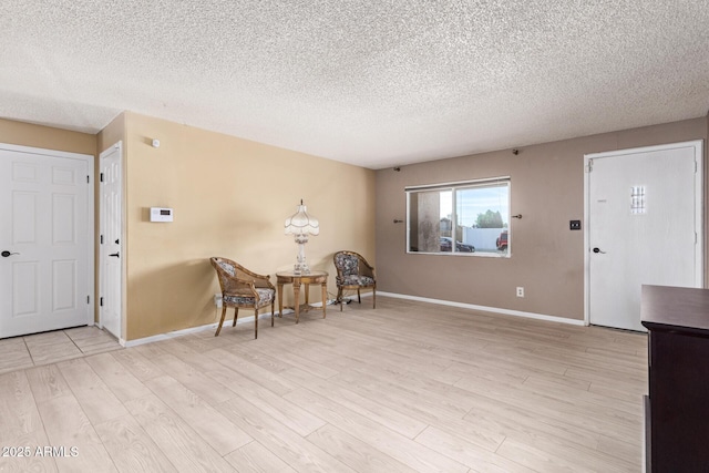 interior space with light hardwood / wood-style floors and a textured ceiling