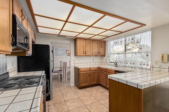 kitchen featuring light tile patterned flooring, sink, tile countertops, kitchen peninsula, and electric stove