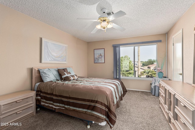 carpeted bedroom with a textured ceiling and ceiling fan