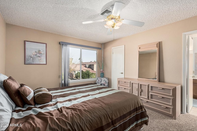 carpeted bedroom with ceiling fan and a textured ceiling