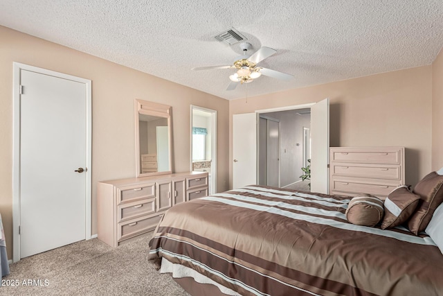 carpeted bedroom featuring ceiling fan and a textured ceiling