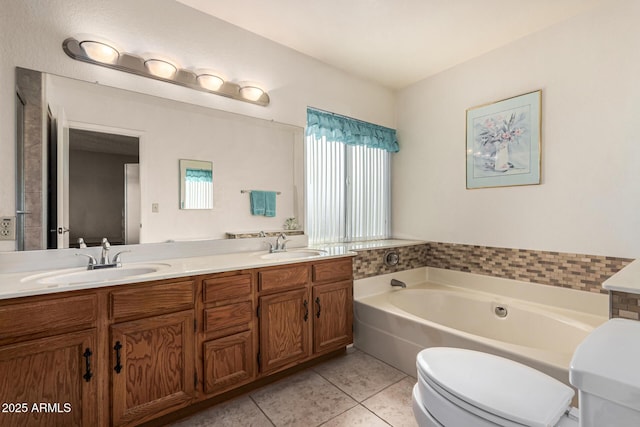 bathroom featuring vanity, toilet, tile patterned flooring, and a washtub