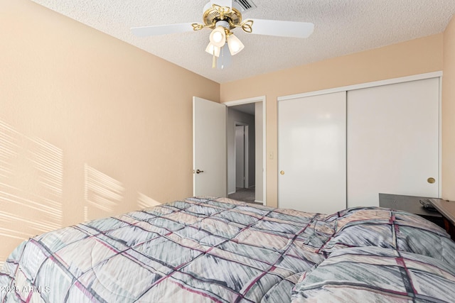 bedroom featuring a textured ceiling, a closet, and ceiling fan